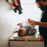 image of a dad changing a diaper